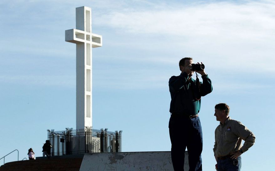 ** FILE ** In this June, 27, 2012, file photo, supporters of a war memorial cross at the Mount Soledad Veterans Memorial in San Diego are not giving up in their fight to keep the 58-year-old monument right where it is in the face of an adverse ruling from a federal appeals court. (Associated Press)