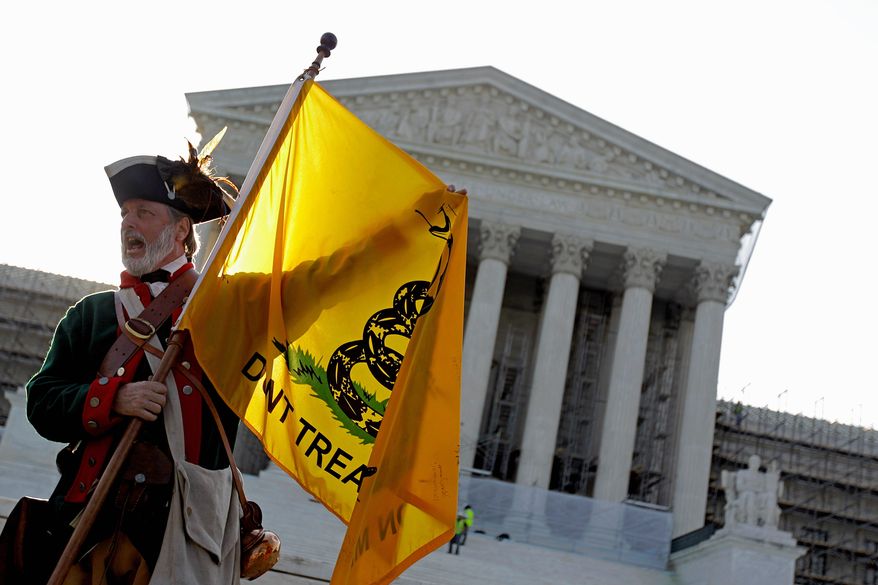 ** FILE ** Tea party supporter William Temple of Brunswick, Ga., on protests against the health care law outside the Supreme Court. Opponents vow to make the law an issue in this fall's presidential and congressional elections. (Associated Press)