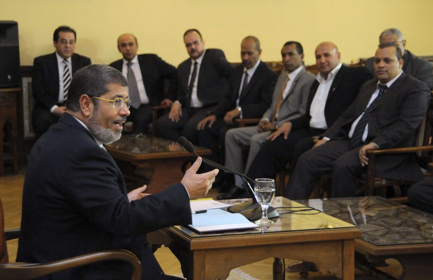 In this photo released by the Egyptian Presidency, President-elect Mohammed Morsi speaks with representatives from political parties in Cairo, Egypt, Thursday, June 28, 2012. (AP Photo/Egyptian Presidency)