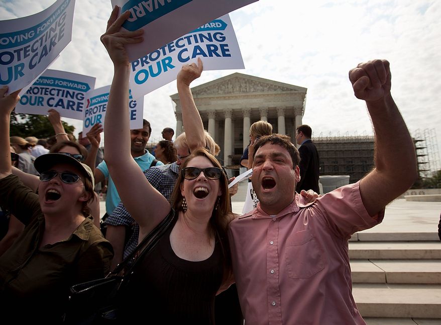 Claire McAndrew of Washington, left, and Donny Kirsch of Washington, celebrate outside the Supreme Court in Washington, Thursday, June 28, 2012, after the courts&#39;s ruling on health care.  (AP Photo/Evan Vucci)