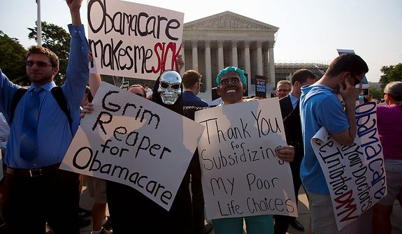 Demonstrators stand outside the Supreme Court in Washington, Thursday, June 28, 2012, before the court&#39;s ruling on health care.  (AP Photo/Evan Vucci)