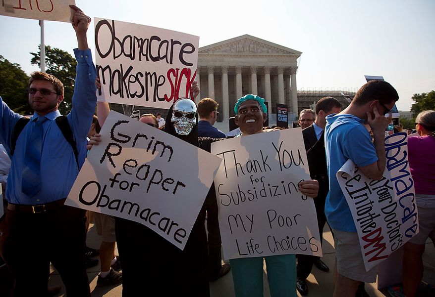Demonstrators stand outside the Supreme Court in Washington, Thursday, June 28, 2012, before the court&#39;s ruling on health care.  (AP Photo/Evan Vucci)