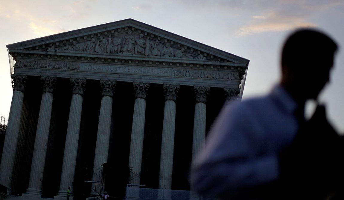The Supreme Court stands in the background as people gather outside Thursday, June 28, 2012, in Washington. Saving its biggest case for last, the Supreme Court is expected to announce its verdict Thursday on President Barack Obama&#x27;s health care law. (AP Photo/David Goldman)
