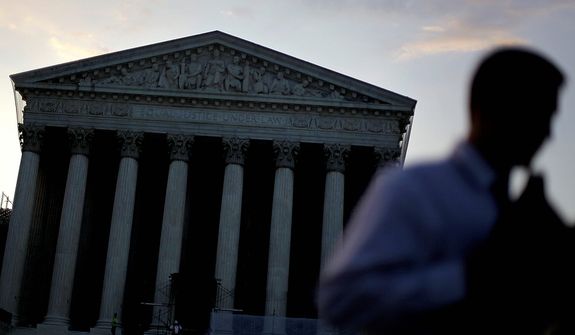 The Supreme Court stands in the background as people gather outside Thursday, June 28, 2012, in Washington. Saving its biggest case for last, the Supreme Court is expected to announce its verdict Thursday on President Barack Obama&#39;s health care law. (AP Photo/David Goldman)