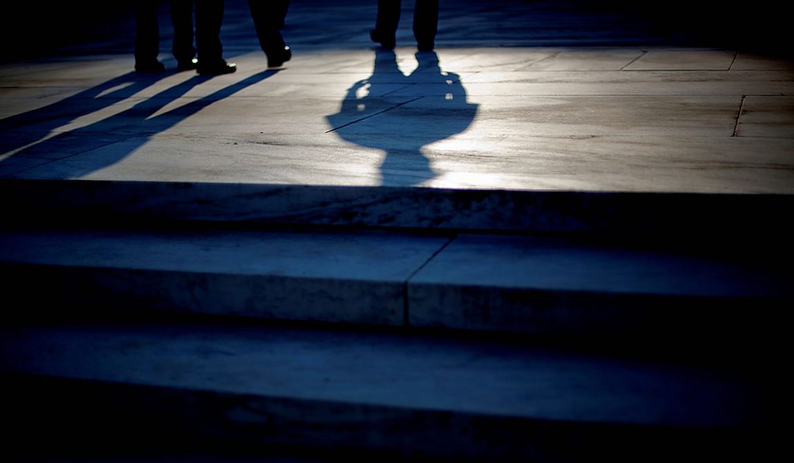 The shadow of an officer is cast as he stands guard on the steps of the Supreme Court in Washington, Thursday, June 28, 2012. Saving its biggest case for last, the Supreme Court is expected to rule on President Barack Obama&#x27;s health care law. (AP Photo/David Goldman)