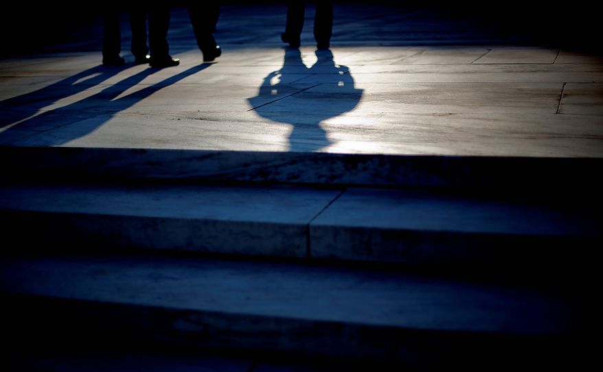 The shadow of an officer is cast as he stands guard on the steps of the Supreme Court in Washington, Thursday, June 28, 2012. Saving its biggest case for last, the Supreme Court is expected to rule on President Barack Obama&#39;s health care law. (AP Photo/David Goldman)