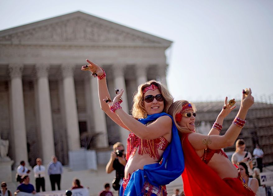 Belly dancers Angela Petry, left, and Jennifer Carpenter-Peak, both of Washington, dance outside the Supreme Court in Washington,Thursday, June 28, 2012, in Washington, as part of a demonstration as the Supreme Court is expected to rule on President Barack Obama&#39;s health care law. (AP Photo/David Goldman)
