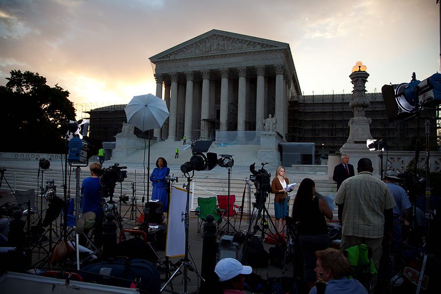 Journalists wait outside the Supreme Court for a landmark decision on health care on Thursday, June 28, 2012 in Washington.  (AP Photo/Evan Vucci)