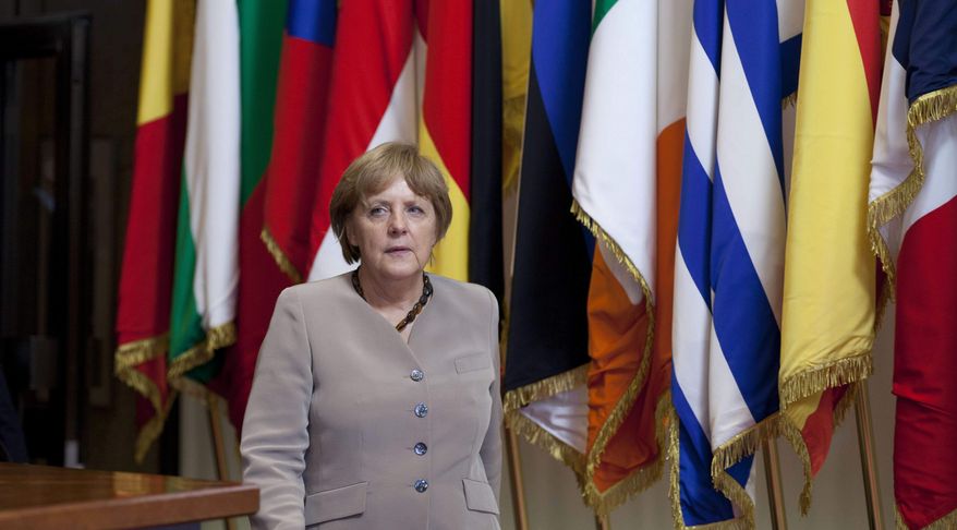 German Chancellor Angela Merkel leaves an EU Summit in Brussels on Friday, June 29, 2012. European leaders have agreed to use the continent&#x27;s permanent bailout fund to recapitalize struggling banks, and agreed to the idea of a tighter union in the long term. (AP Photo/Virginia Mayo)