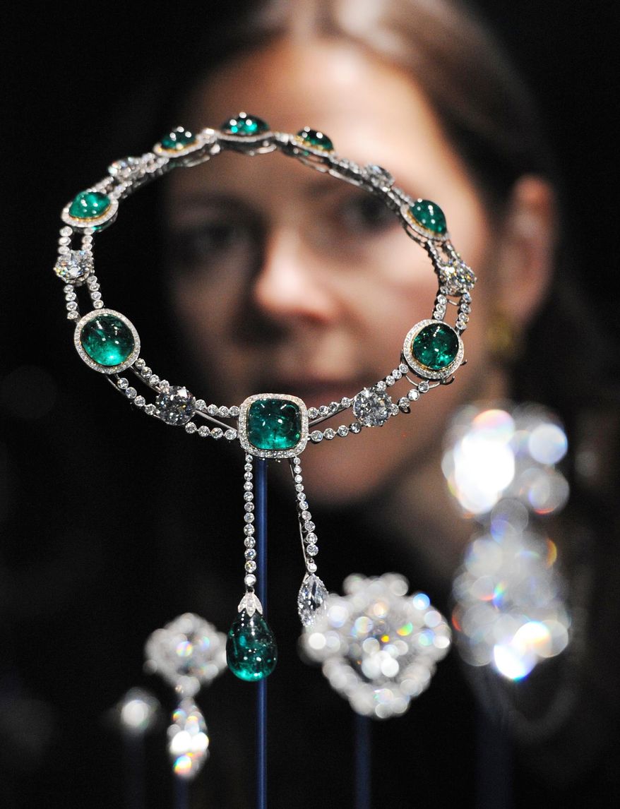 Curator Caroline de Guitaut stands behind the Delhi Durbar necklace and Cullinan pendant made up of diamonds and emeralds, created for the Delhi Durbar of 1911 and owned by Queen Mary, at a new exhibition at Buckingham Palace in London on June 28, 2012. The exhibition shows jewels collected by six monarchs over three centuries to mark the Queen's Diamond jubilee this summer. (Associated Press/Stefan Rousseau/PA Wire)