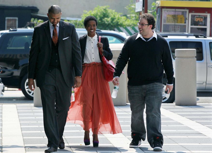 ** FILE ** Reclusive singer Lauryn Hill (center) arrives at federal court on Friday, June, 29, 2012, in Newark, N.J. (AP Photo/Mel Evans)