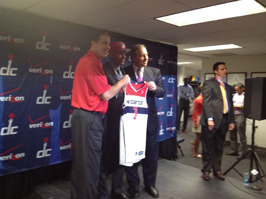 Bradley Beal poses for photographs with Washington Wizards coach Randy Wittman (left) and team president Ernie Grunfeld (right). (Nicolas Nightingale/The Washington Times)