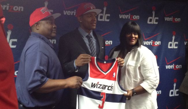 Bradley Beal, the Washington Wizards&#x27; No. 3 pick in Thursday&#x27;s draft, stands for photos with his parents. (Nicolas Nightingale/The Washington Times)