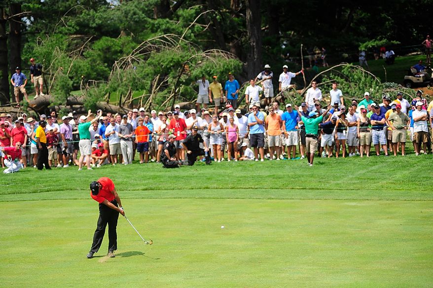Tiger Woods hits an approach shot on the sixth hole at Congressional Country Club during final round play of the AT&T National golf tournament, Bethesda, Md., Sunday, July 1, 2012. The tournament was closed to the public on Saturday during third round play due to damage from a storm Friday night. (Ryan M.L. Young/The Washington Times)
