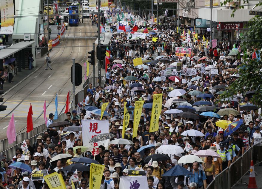 Tens of thousands of Hong Kong residents take part in an annual pro-democracy march in Hong Kong on Sunday, July 1, 2012. (AP Photo/Kin Cheung)