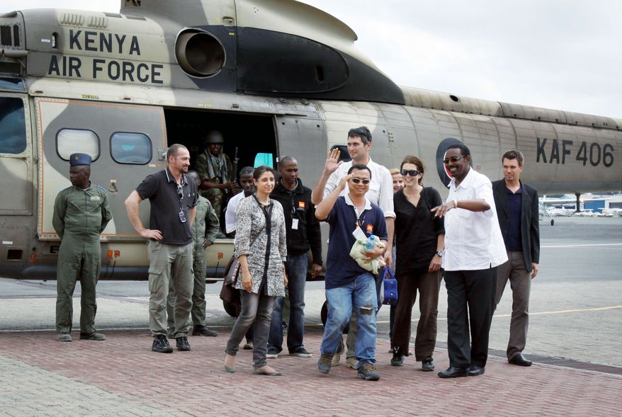 ASSOCIATED PRESS
Four aid workers arrive by Kenyan military helicopter in Nairobi, Kenya, on Monday, three days after they were kidnapped by gunmen who attacked a convoy from a Kenyan refugee camp. "We are happy. We are back. We are alive and we are happy this has ended," said Qurat-Ul-Ain Sadazai, one of the four workers with the Norwegian Refugee Council. They were rescued by a pro-government Somali militia group.