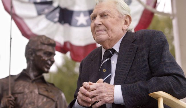 Actor Andy Griffith sits in front of a bronze statue of Sheriff Andy Taylor and son Opie from &quot;The Andy Griffith Show&quot; after the unveiling ceremony in Raleigh, N.C., in October 2003. (AP Photo/Bob Jordan)