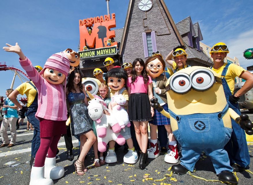 This image released by Universal Orlando shows actresses with the characters they voiced from the animated film "Despicable Me," from left, Dana Gaier with the character Edith, Elsie Fisher with Agnes and Miranda Cosgrove, who voiced Margo, at the grand opening of the 3-D ride "Despicable Me Minion Mayhem," based on the animated film, Monday, July 2, 2012 in Orlando, Fla. (AP Photo/Universal Orlando)