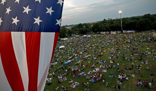 **FILE** A U.S. flag flies July 3, 2012, over a field during the Fanfare and Fireworks celebration at the University of Florida in Gainesville, Fla. (Associated Press/The Gainesville Sun)