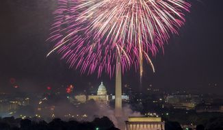 Fireworks can be seen as they explode over the National Mall to celebrate Independence Day, Arlington, Va., Wednesday, July 4, 2012. (Andrew Harnik/The Washington Times)