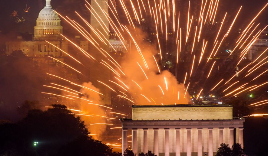 Fireworks can be seen from the Top of the Town as they explode over the National Mall to celebrate Independence Day. (Andrew Harnik/The Washington Times)
