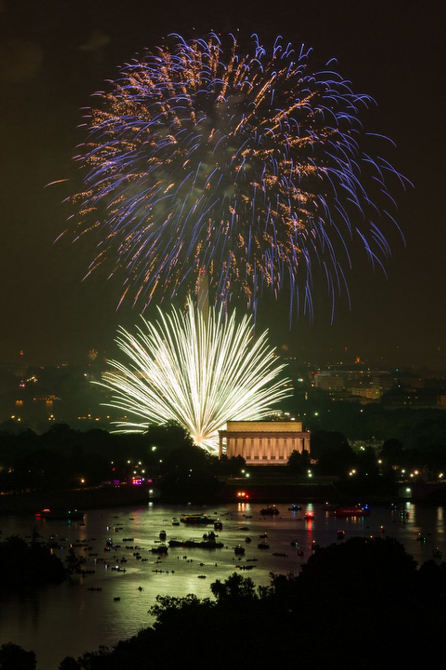 Fireworks can be seen from the Top of the Town as they explode over the National Mall to celebrate Independence Day. (Andrew Harnik/The Washington Times)