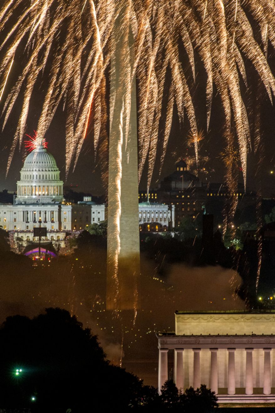 Fireworks can be seen from the Top of the Town as they explode over the National Mall to celebrate Independence Day. (Andrew Harnik/The Washington Times)