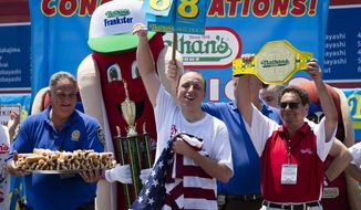 Five-time reigning champion Joey Chestnut celebrates after he wins his sixth straight Coney Island hot dog eating contest on Wednesday, July 4, 2012  at Coney Island, in the Brooklyn borough of New York. Chestnut tied his personal best and the record with eating 68 hot dogs. Last year, Chestnut won with 62 hot dogs. (AP Photo/John Minchillo)