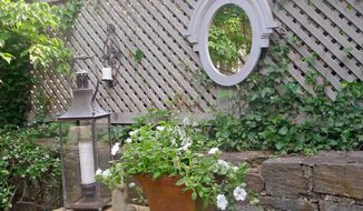 Photo courtesy of kelley interior design
Kelley Proxmire of Kelley Interior Design in Bethesda suggests using a mirror on an outdoor fence or various groupings of potted plants to add interest to a patio or deck.