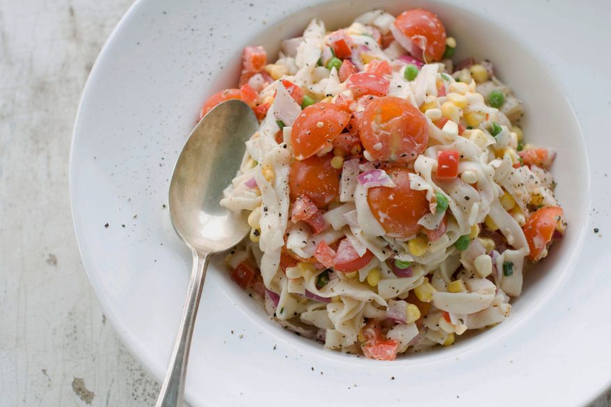 Fettuccine-style shirataki noodles are mixed with fresh summer vegetables for a delicious and healthy pasta salad. (Associated Press)