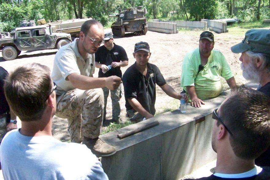 Drive-a-Tank owner Tony Borglum gives participants a lesson in driving a tank. The Kasota, Minn., business gives customers a chance to take their inner Rambo around a mile-long dirt course and crush a car. Other weapons and crushables are available.