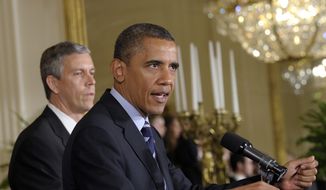 President Obama (right), with Education Secretary Arne Duncan at his side, calls on Congress during a June 21, 2012, news conference at the White House to stop interest rates on student loans from doubling. (Associated Press) ** FILE **