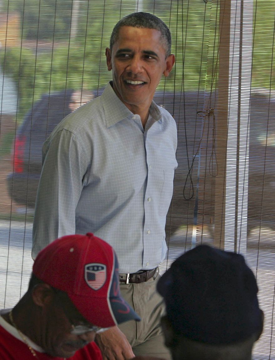 President Obama meets local residents July 6, 2012, during a stop at Ann's Place in Akron, Ohio, during a two-day campaign bus trip in Ohio and Pennsylvania. (Associated Press/Akron Beacon Journal)