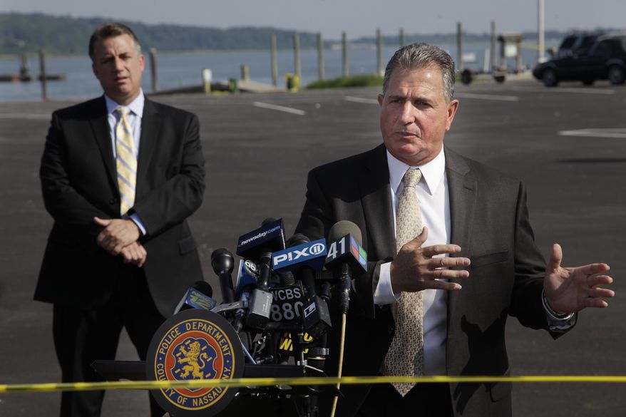 Nassau County Police Detective Lt. John Azzata, right, gives information about a fatal boating accident during a news conference in Oyster Bay, N.Y., Thursday, July 5, 2012. Police say three bodies have been pulled out of New York's Long Island Sound after a yacht capsized on the Fourth of July. (AP Photo/Seth Wenig)