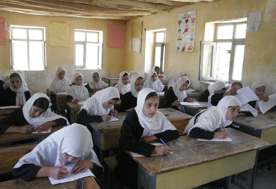 In this Thursday, July 5, 2012, photo, Afghan students are seen during passing their midyear school examinations at the Mirbachakot high school on the outskirts of Kabul, Afghanistan. Afghanistan will seek at least $4 billion from international donors this weekend at a crucial aid conference aimed at propping up the country after most foreign combat troops leave at the end of 2014. (AP Photo/Musadeq Sadeq)