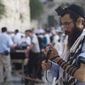 ** FILE ** In this Monday, July 2, 2012, an Israeli soldier prays next to the Western Wall, the holiest site where Jews can pray, in Jerusalem&#x27;s Old City. (AP Photo/Dan Balilty)

