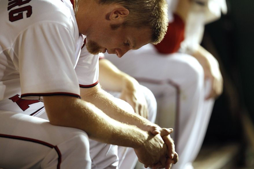 Washington Nationals starting pitcher Stephen Strasburg sits in the dugout after giving up three runs (two earned) on eight hits and one walk in his team's 5-1 loss to the Colorado Rockies on Friday. (AP Photo/Evan Vucci)