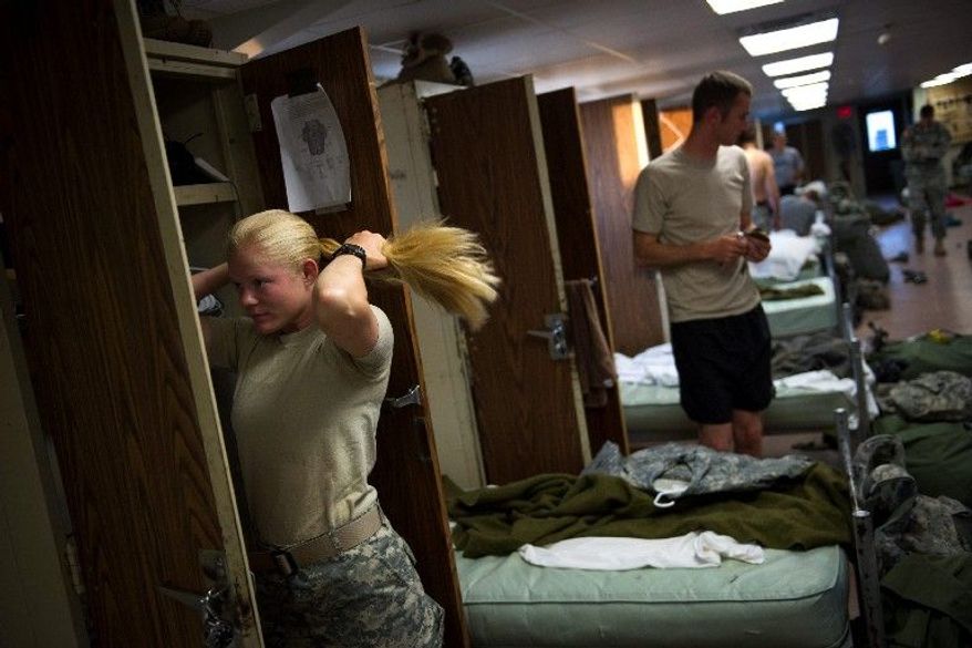 Army Capt. Aston Armstrong brushes her hair after waking up in quarters she shares with men in sapper training after spending her first night in an actual bed following two grueling weeks in the field. Trainees rig explosives, detect mines and set up firing systems. The training pushes them to their physical and mental limits. (Rod Lamkey Jr./The Washington Times)