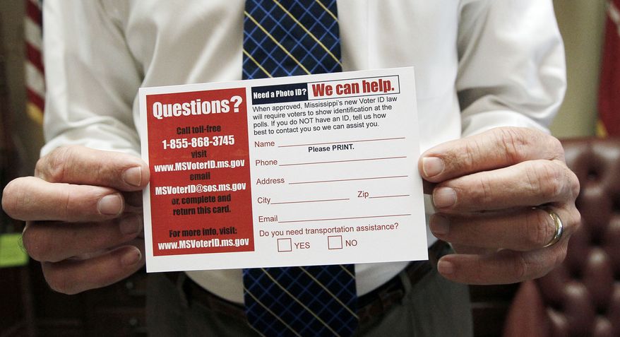 **FILE** Mississippi Secretary of State Delbert Hosemann holds a postcard to help identify voters in need of a free state-government issued card on June 19, 2012. The card will be issued through his office in Jackson, Miss., at no charge. (Associated Press)