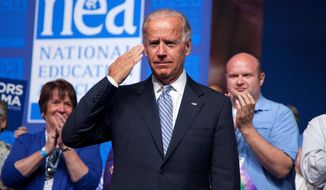 ** FILE ** Vice President Joseph R. Biden salutes after arriving to speak before the 2012 National Educational Association&#39;s annual meeting on Tuesday, July 3, 2012, in Washington. (Associated Press)