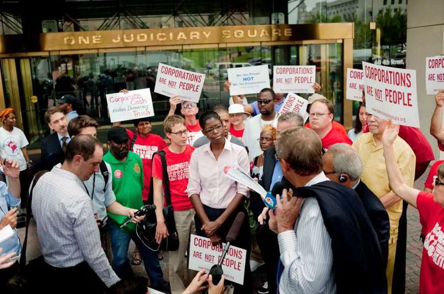 Initiative 70 delivered 30,000 signatures to ban corporate contributions to local politicians during a press conference held at Judiciary Square on Monday, July 9, 2012, in the District (Raymond Thompson/The Washington Times)