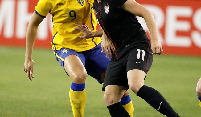 Ali Krieger (right) had hoped to be about 90 percent healthy by the end of June, but when the Olympic roster was set May 27, her chances of competing were over. (Associated Press)