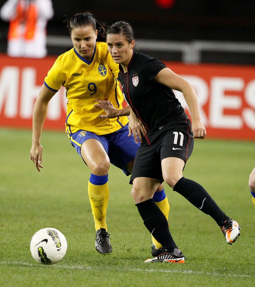 Ali Krieger (right) had hoped to be about 90 percent healthy by the end of June, but when the Olympic roster was set May 27, her chances of competing were over. (Associated Press)