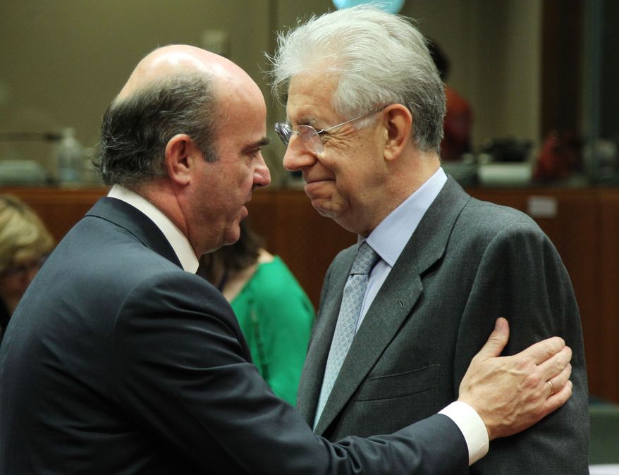 Italian Finance Minister Mario Monti (right) talks with Spanish Finance Minister Luis de Guindos Jurado during the meeting of European Union finance ministers in Brussels on Tuesday, July 10, 2012. (AP Photo/Yves Logghe)

