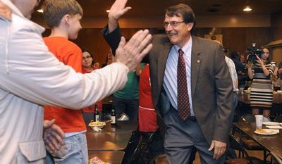 Democratic state Senate candidate John Lehman gives a high-five to a young supporter as he arrives for an election-night party at the Racine Labor Center in Racine, Wis., on Tuesday, June 5, 2012. (AP Photo/Scott Anderson, Journal Times)