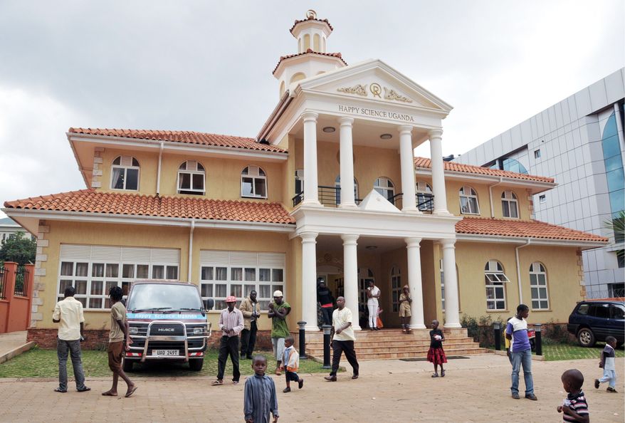 Ugandan Happy Science believers depart after prayers July 1 at their church in Kampala. Church officials do not know precisely how many converts they have won since coming to Uganda in 2008. (Associated Press)