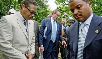 D.C. Mayor Vincent C. Gray is surrounded as he answers reporters' questions about campaign operative Jeanne C. Harris who pleaded guilty Tuesday to funneling undocumented campaign funds to his campaign. (Andrew Harnik/The Washington Times)