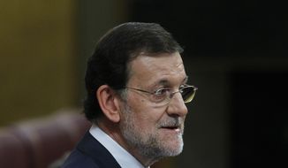Spanish Prime Minister Mariano Rajoy speaks to the parliament in Madrid on Wednesday, July 11, 2012. (AP Photo/Andres Kudacki)