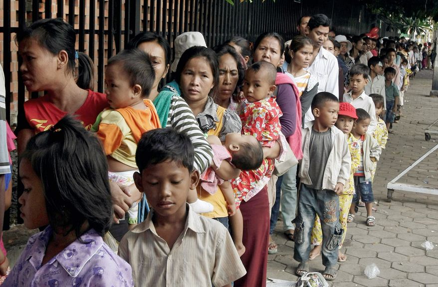 Cambodian villagers wait for checkups outside a children's hospital in Phnom Penh Wednesday. A virulent form of hand, foot and mouth disease has killed hundreds of young children in Asia, where the illness is commong and usually not severe. (Associated Press)
