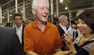 In this July 6, 2012, photograph, following the unveiling of GreenTech Automotive&#39;s new electric MyCar, former President Bill Clinton speaks to attendees at their manufacturing facility in Horn Lake, Miss. (AP Photo/Rogelio V. Solis)